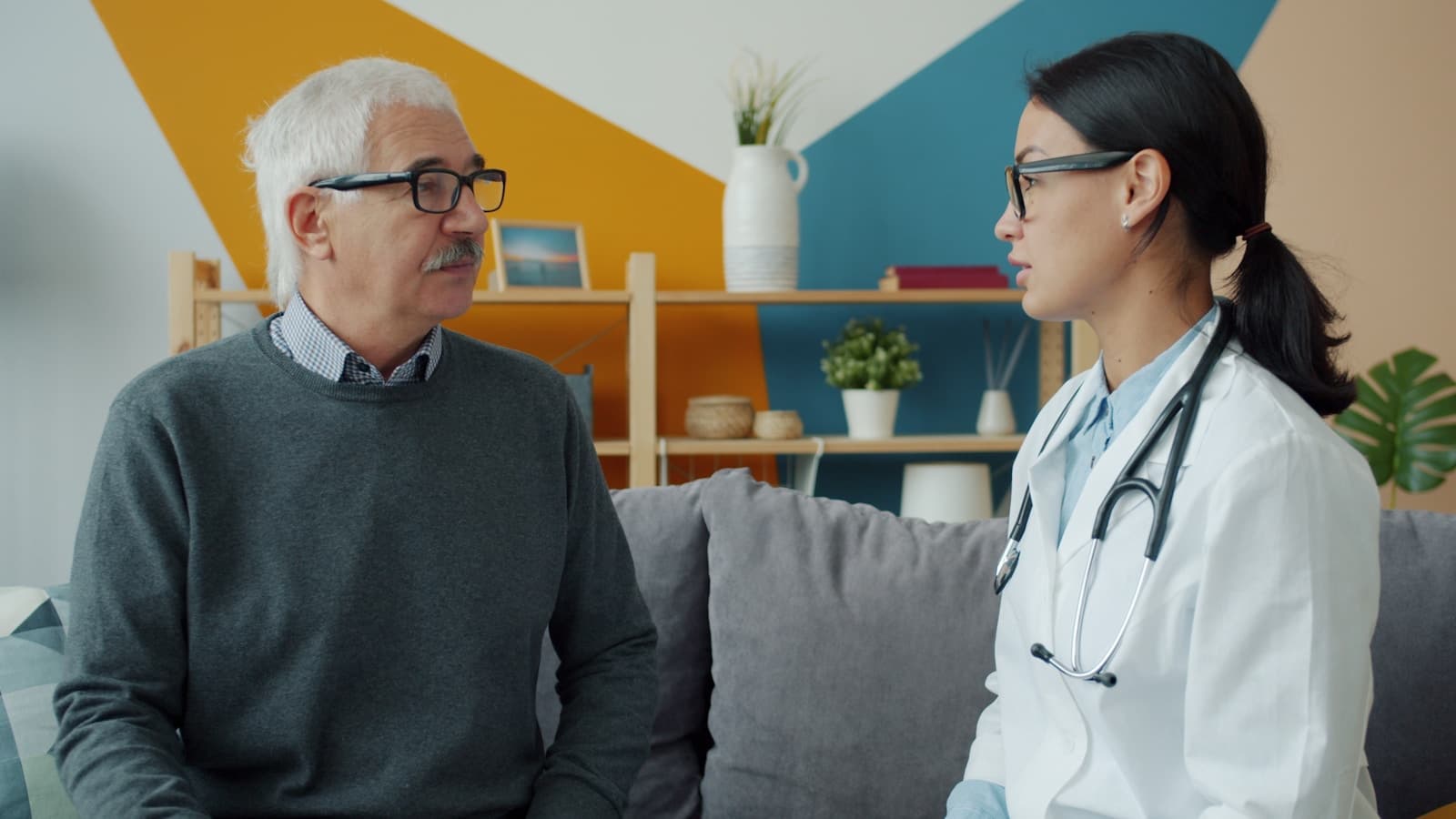 Pharmacist answering a senior's medication questions face to face